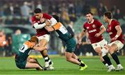12 July 2025; Sione Tuipulotu of British & Irish Lions is tackled by Tane Edmed, left, and David Havili of AUNZ XV during the tour match between AUNZ XV and the British & Irish Lions at the Adelaide Oval in Adelaide, Australia. Photo by Brendan Moran/Sportsfile