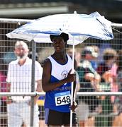 12 July 2025; Joseph Magbagbeola of Ratoath A.C., Dublin, shields from the sun with an umbrella before competing in Boys U16 Long Jump during day three of the Juvenile Track and Field Championships at Tullamore Harriers Athletics Club in Tullamore, Offaly. Photo by Ben McShane/Sportsfile
