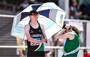 12 July 2025;  Dylan Brennan of Clongriffin A.C., Dublin, shields from the sun with an umbrella before competing in Boys U16 Long Jump during day three of the Juvenile Track and Field Championships at Tullamore Harriers Athletics Club in Tullamore, Offaly. Photo by Ben McShane/Sportsfile