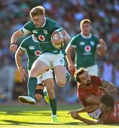 12 July 2025; Tommy O'Brien of Ireland on his way to scoring his side's fifth try despite the attempted tackles from Simao Bento of Portugal during the International Rugby Test match between Portugal and Ireland at Estádio Nacional do Jamor in Lisbon, Portugal. Photo by David Fitzgerald/Sportsfile