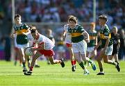 12 July 2025; Harry McVeigh, Bunscoil Bheanna Boirche, Castlewellan, Down, representing Tyrone, in action against James Dunne, Holy Family National School, Tubbercurry, Sligo, representing Kerry, and Sean Hurley, Gaelscoil Dr Uí Shuilleabháin, Gort Na Cloiche, Corcaigh, Ionadaíocht Ciarraí, right, during the GAA INTO Cumann na mBunscol Respect Exhibition Go Games match at the GAA Football All-Ireland Senior Championship semi-final match between Kerry and Tyrone at Croke Park in Dublin. Photo by Ray McManus/Sportsfile