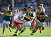 12 July 2025; Harry McVeigh, Bunscoil Bheanna Boirche, Castlewellan, Down, representing Tyrone, in action against James Dunne, Holy Family National School, Tubbercurry, Sligo, representing Kerry, and Sean Hurley, Gaelscoil Dr Uí Shuilleabháin, Gort Na Cloiche, Corcaigh, Ionadaíocht Ciarraí, left, during the GAA INTO Cumann na mBunscol Respect Exhibition Go Games match at the GAA Football All-Ireland Senior Championship semi-final match between Kerry and Tyrone at Croke Park in Dublin. Photo by Ray McManus/Sportsfile