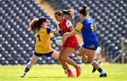 13 July 2025; Eimear Byrne of Louth is tackled by Longford goalkeeper Aoife Cooney during the TG4 All-Ireland Ladies Football Junior Championship semi-final match between Louth and Longford at St Tiernach’s Park in Clones, Monaghan. Photo by Ben McShane/Sportsfile
