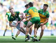 13 July 2025; Mathew Costello of Meath is tackled by Donegal players, from left, Dáire Ó Baoill, Conor O'Donnell and Odhran McFadden Ferry during the GAA Football All-Ireland Senior Championship semi-final match between Meath and Donegal at Croke Park in Dublin. Photo by John Sheridan/Sportsfile