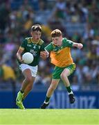 13 July 2025; Mark Cunningham, St Mary's National School, Drumlish, Longford, representing Meath, in action against Stephen Mulchrone, St Peters National School, Castlebar, Mayo, representing Donegal, during the GAA INTO Cumann na mBunscol Respect Exhibition Go Games match at the GAA Football All-Ireland Senior Championship semi-final match between Meath and Donegal at Croke Park in Dublin. Photo by Ray McManus/Sportsfile
