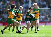 13 July 2025; Sara Donegan, Bennekerry National School, Bennekerry, Carlow, representing Meath, is tackled by Síne Nic Giolla Chomhaill, Gaelscoil Ultain, Baile Mhuineacháin, Mhuineacháin, ag déanamh ionadaíochta ar Dhún na nGall during the GAA INTO Cumann na mBunscol Respect Exhibition Go Games match at the GAA Football All-Ireland Senior Championship semi-final match between Meath and Donegal at Croke Park in Dublin. Photo by Ray McManus/Sportsfile