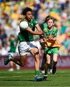 13 July 2025; Daniel Gallagher, The Quay National School, Ballina, Mayo, representing Donegal, in action against Trayvon Akahomen, St Mochta's National School, Clonsilla, Dublin, representing Meath, during the GAA INTO Cumann na mBunscol Respect Exhibition Go Games match at the GAA Football All-Ireland Senior Championship semi-final match between Meath and Donegal at Croke Park in Dublin. Photo by Seb Daly/Sportsfile