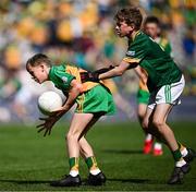 13 July 2025; Daniel Gallagher, The Quay National School, Ballina, Mayo, representing Donegal, in action against David Judge, Bayside Senior School, Sutton, Dublin, representing Meath, during the GAA INTO Cumann na mBunscol Respect Exhibition Go Games match at the GAA Football All-Ireland Senior Championship semi-final match between Meath and Donegal at Croke Park in Dublin. Photo by Seb Daly/Sportsfile