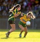 15 July 2025; Laura Boyle of Donegal is tackled by Eibhlin Guckian of Leitrim during LGFA All-Ireland U16 C Championship final match between Donegal and Leitrim at Tempo Maguires GAC in Tempo, Fermanagh. Photo by Ben McShane/Sportsfile