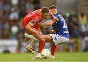 16 July 2025; Evan Caffrey of Shelbourne is tackled by Ethan McGee of Linfield during the UEFA Champions League First Qualifying Round second leg match between Linfield and Shelbourne at Clearer Twist National Football Stadium at Windsor Park in Belfast. Photo by Ben McShane/Sportsfile