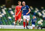 16 July 2025; Chris Shields of Linfield in action against Harry Wood of Shelbourne during the UEFA Champions League First Qualifying Round second leg match between Linfield and Shelbourne at Clearer Twist National Football Stadium at Windsor Park in Belfast. Photo by Ben McShane/Sportsfile