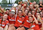 16 July 2025; Armagh captain Cassie Henderson celebrates with the cup alongside her teammates after their side's victory in the LGFA All-Ireland U16 B Championship final match between Armagh and Galway at Glennon Brothers Pearse Park in Longford. Photo by Stephen Marken/Sportsfile