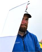 17 July 2025; Shane Lowry of Ireland uses an umbrella the shelter from the rain during day one of The 153rd Open Championship at Royal Portrush Golf Club in Portrush, Antrim. Photo by David Fitzgerald/Sportsfile