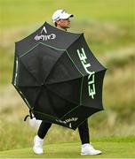 17 July 2025; Thomas Detry of Belgium uses an umbrella during day one of The 153rd Open Championship at Royal Portrush Golf Club in Portrush, Antrim. Photo by Ramsey Cardy/Sportsfile