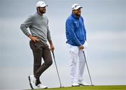 17 July 2025; Scottie Scheffler of USA and Shane Lowry of Ireland wait on the fifth green during day one of The 153rd Open Championship at Royal Portrush Golf Club in Portrush, Antrim. Photo by David Fitzgerald/Sportsfile