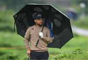 17 July 2025; Xander Schauffele of USA uses an umbrella to shelter from the rain on the 12th hole during day one of The 153rd Open Championship at Royal Portrush Golf Club in Portrush, Antrim. Photo by David Fitzgerald/Sportsfile