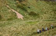 18 July 2025; Scottie Scheffler of USA, Shane Lowry of Ireland and Collin Morikawa of USA walk to the seventh fairway during day two of The 153rd Open Championship at Royal Portrush Golf Club in Portrush, Antrim. Photo by Ramsey Cardy/Sportsfile