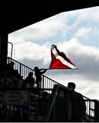 18 July 2025; A Galway United supporter waves a flag in the main stand before the Sports Direct Men’s FAI Cup second round match between Galway United and Tolka Rovers at Eamonn Deacy Park in Galway. Photo by Piaras Ó Mídheach/Sportsfile