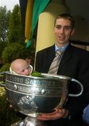 27 September 2004; Kerry's Marc O'Se and 14 week old Mairead Quinlan with the Sam Maguire cup prior to the teams departure. Burlington Hotel, Dublin. Picture credit; Damien Eagers / SPORTSFILE