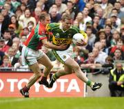 26 September 2004; Dara O Cinneide, Kerry, in action against Gary Ruane, Mayo. Bank of Ireland All-Ireland Senior Football Championship Final, Kerry v Mayo, Croke Park, Dublin. Picture credit; Brendan Moran / SPORTSFILE *** Local Caption *** Any photograph taken by SPORTSFILE during, or in connection with, the 2004 Bank of Ireland All-Ireland Senior Football Final which displays GAA logos or contains an image or part of an image of any GAA intellectual property, or, which contains images of a GAA player/players in their playing uniforms, may only be used for editorial and non-advertising purposes.  Use of photographs for advertising, as posters or for purchase separately is strictly prohibited unless prior written approval has been obtained from the Gaelic Athletic Association.