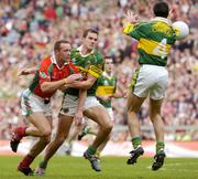 26 September 2004; David Brady, Mayo, in action against Eoin Brosnan and Aidan O'Mahony (4), Kerry. Bank of Ireland All-Ireland Senior Football Championship Final, Kerry v Mayo, Croke Park, Dublin. Picture credit; Brendan Moran / SPORTSFILE *** Local Caption *** Any photograph taken by SPORTSFILE during, or in connection with, the 2004 Bank of Ireland All-Ireland Senior Football Final which displays GAA logos or contains an image or part of an image of any GAA intellectual property, or, which contains images of a GAA player/players in their playing uniforms, may only be used for editorial and non-advertising purposes.  Use of photographs for advertising, as posters or for purchase separately is strictly prohibited unless prior written approval has been obtained from the Gaelic Athletic Association.