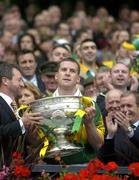 26 September 2004; President of the GAA Sean Kelly presents the Sam Maguire cup to Kerry captain Dara O Cinneide. Bank of Ireland All-Ireland Senior Football Championship Final, Kerry v Mayo, Croke Park, Dublin. Picture credit; Brendan Moran / SPORTSFILE *** Local Caption *** Any photograph taken by SPORTSFILE during, or in connection with, the 2004 Bank of Ireland All-Ireland Senior Football Final which displays GAA logos or contains an image or part of an image of any GAA intellectual property, or, which contains images of a GAA player/players in their playing uniforms, may only be used for editorial and non-advertising purposes.  Use of photographs for advertising, as posters or for purchase separately is strictly prohibited unless prior written approval has been obtained from the Gaelic Athletic Association.