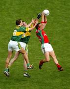 26 September 2004; David Brady, Mayo, wins possession ahead of Kerry's Eoin Brosnan, 8, and William Kirby. Bank of Ireland All-Ireland Senior Football Championship Final, Kerry v Mayo, Croke Park, Dublin. Picture credit; Pat Murphy / SPORTSFILE *** Local Caption *** Any photograph taken by SPORTSFILE during, or in connection with, the 2004 Bank of Ireland All-Ireland Senior Football Final which displays GAA logos or contains an image or part of an image of any GAA intellectual property, or, which contains images of a GAA player/players in their playing uniforms, may only be used for editorial and non-advertising purposes.  Use of photographs for advertising, as posters or for purchase separately is strictly prohibited unless prior written approval has been obtained from the Gaelic Athletic Association.