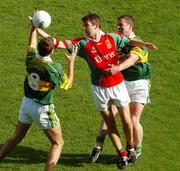 26 September 2004; Ronan McGarrity, Mayo, in action against Kerry's Eoin Brosnan, 8, and Dara O Cinneide. Bank of Ireland All-Ireland Senior Football Championship Final, Kerry v Mayo, Croke Park, Dublin. Picture credit; Pat Murphy / SPORTSFILE *** Local Caption *** Any photograph taken by SPORTSFILE during, or in connection with, the 2004 Bank of Ireland All-Ireland Senior Football Final which displays GAA logos or contains an image or part of an image of any GAA intellectual property, or, which contains images of a GAA player/players in their playing uniforms, may only be used for editorial and non-advertising purposes.  Use of photographs for advertising, as posters or for purchase separately is strictly prohibited unless prior written approval has been obtained from the Gaelic Athletic Association.