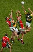 26 September 2004; Kerry's Seamus Moynihan, left, and Eoin Brosnan, right, contest a high ball against Mayo's David Heany, left, and David Brady, right, while team-mate Trevor Mortimer, 14, awaits the breaking ball. Bank of Ireland All-Ireland Senior Football Championship Final, Kerry v Mayo, Croke Park, Dublin. Picture credit; Pat Murphy / SPORTSFILE *** Local Caption *** Any photograph taken by SPORTSFILE during, or in connection with, the 2004 Bank of Ireland All-Ireland Senior Football Final which displays GAA logos or contains an image or part of an image of any GAA intellectual property, or, which contains images of a GAA player/players in their playing uniforms, may only be used for editorial and non-advertising purposes.  Use of photographs for advertising, as posters or for purchase separately is strictly prohibited unless prior written approval has been obtained from the Gaelic Athletic Association.