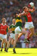 26 September 2004; David Brady, Mayo, in action against William Kirby, Kerry. Bank of Ireland All-Ireland Senior Football Championship Final, Kerry v Mayo, Croke Park, Dublin. Picture credit; Ray McManus / SPORTSFILE *** Local Caption *** Any photograph taken by SPORTSFILE during, or in connection with, the 2004 Bank of Ireland All-Ireland Senior Football Final which displays GAA logos or contains an image or part of an image of any GAA intellectual property, or, which contains images of a GAA player/players in their playing uniforms, may only be used for editorial and non-advertising purposes.  Use of photographs for advertising, as posters or for purchase separately is strictly prohibited unless prior written approval has been obtained from the Gaelic Athletic Association.