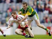 26 September 2004; Aiden Cassidy, Tyrone, in action against Luke Quinn, Kerry. All-Ireland Minor Football Championship Final, Kerry v Tyrone, Croke Park, Dublin. Picture credit; Brian Lawless / SPORTSFILE *** Local Caption *** Any photograph taken by SPORTSFILE during, or in connection with, the 2004 All-Ireland Minor Football Final which displays GAA logos or contains an image or part of an image of any GAA intellectual property, or, which contains images of a GAA player/players in their playing uniforms, may only be used for editorial and non-advertising purposes.  Use of photographs for advertising, as posters or for purchase separately is strictly prohibited unless prior written approval has been obtained from the Gaelic Athletic Association.
