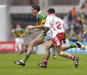 26 September 2004; Anthony Maher, Kerry, in action against Niall McGinn, Tyrone. All-Ireland Minor Football Championship Final, Kerry v Tyrone, Croke Park, Dublin. Picture credit; Brian Lawless / SPORTSFILE *** Local Caption *** Any photograph taken by SPORTSFILE during, or in connection with, the 2004 All-Ireland Minor Football Final which displays GAA logos or contains an image or part of an image of any GAA intellectual property, or, which contains images of a GAA player/players in their playing uniforms, may only be used for editorial and non-advertising purposes.  Use of photographs for advertising, as posters or for purchase separately is strictly prohibited unless prior written approval has been obtained from the Gaelic Athletic Association.
