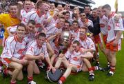 26 September 2004; The Tyrone minor team celebrate with the Tom Markham cup after victory in the final. All-Ireland Minor Football Championship Final, Kerry v Tyrone, Croke Park, Dublin. Picture credit; Brian Lawless / SPORTSFILE *** Local Caption *** Any photograph taken by SPORTSFILE during, or in connection with, the 2004 All-Ireland Minor Football Final which displays GAA logos or contains an image or part of an image of any GAA intellectual property, or, which contains images of a GAA player/players in their playing uniforms, may only be used for editorial and non-advertising purposes.  Use of photographs for advertising, as posters or for purchase separately is strictly prohibited unless prior written approval has been obtained from the Gaelic Athletic Association.
