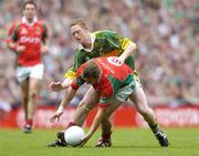 26 September 2004; Dermot Geraghty, Mayo, in action against Colm Cooper, Kerry. Bank of Ireland All-Ireland Senior Football Championship Final, Kerry v Mayo, Croke Park, Dublin. Picture credit; Brian Lawless / SPORTSFILE *** Local Caption *** Any photograph taken by SPORTSFILE during, or in connection with, the 2004 Bank of Ireland All-Ireland Senior Football Final which displays GAA logos or contains an image or part of an image of any GAA intellectual property, or, which contains images of a GAA player/players in their playing uniforms, may only be used for editorial and non-advertising purposes.  Use of photographs for advertising, as posters or for purchase separately is strictly prohibited unless prior written approval has been obtained from the Gaelic Athletic Association.