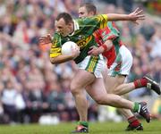 26 September 2004; John Crowley, Kerry, in action against Gary Ruane, Mayo. Bank of Ireland All-Ireland Senior Football Championship Final, Kerry v Mayo, Croke Park, Dublin. Picture credit; Brian Lawless / SPORTSFILE *** Local Caption *** Any photograph taken by SPORTSFILE during, or in connection with, the 2004 Bank of Ireland All-Ireland Senior Football Final which displays GAA logos or contains an image or part of an image of any GAA intellectual property, or, which contains images of a GAA player/players in their playing uniforms, may only be used for editorial and non-advertising purposes.  Use of photographs for advertising, as posters or for purchase separately is strictly prohibited unless prior written approval has been obtained from the Gaelic Athletic Association.