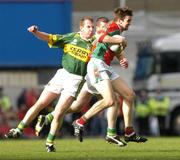 26 September 2004; Ronan McGarrity, Mayo, in action against William Kirby, Kerry. Bank of Ireland All-Ireland Senior Football Championship Final, Kerry v Mayo, Croke Park, Dublin. Picture credit; Brian Lawless / SPORTSFILE *** Local Caption *** Any photograph taken by SPORTSFILE during, or in connection with, the 2004 Bank of Ireland All-Ireland Senior Football Final which displays GAA logos or contains an image or part of an image of any GAA intellectual property, or, which contains images of a GAA player/players in their playing uniforms, may only be used for editorial and non-advertising purposes.  Use of photographs for advertising, as posters or for purchase separately is strictly prohibited unless prior written approval has been obtained from the Gaelic Athletic Association.