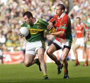 26 September 2004; Michael McCarthy, Kerry, in action against Trevor Mortimer, Mayo. Bank of Ireland All-Ireland Senior Football Championship Final, Kerry v Mayo, Croke Park, Dublin. Picture credit; Brian Lawless / SPORTSFILE *** Local Caption *** Any photograph taken by SPORTSFILE during, or in connection with, the 2004 Bank of Ireland All-Ireland Senior Football Final which displays GAA logos or contains an image or part of an image of any GAA intellectual property, or, which contains images of a GAA player/players in their playing uniforms, may only be used for editorial and non-advertising purposes.  Use of photographs for advertising, as posters or for purchase separately is strictly prohibited unless prior written approval has been obtained from the Gaelic Athletic Association.