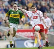 26 September 2004; Raymond Mulgrew, Tyrone, in action against Brian Moran, Kerry. All-Ireland Minor Football Championship Final, Kerry v Tyrone, Croke Park, Dublin. Picture credit; Damien Eagers / SPORTSFILE *** Local Caption *** Any photograph taken by SPORTSFILE during, or in connection with, the 2004 All-Ireland Minor  Football Final which displays GAA logos or contains an image or part of an image of any GAA intellectual property, or, which contains images of a GAA player/players in their playing uniforms, may only be used for editorial and non-advertising purposes.  Use of photographs for advertising, as posters or for purchase separately is strictly prohibited unless prior written approval has been obtained from the Gaelic Athletic Association.