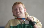 30 September 2004; John McCarthy, a member of the Ireland Paralympic team, and Silver Medalist in the F32/51 Discus, on the teams arrival home from Athens. Dublin Airport, Dublin. Picture credit; Brian Lawless / SPORTSFILE