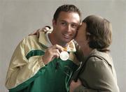 30 September 2004; David Malone, a member of the Ireland Paralympic team, and silver medallist in the 100m backstroke S8, is welcomed home by his mother Margaret, on the teams arrival home from Athens. Dublin Airport, Dublin. Picture credit; Brian Lawless / SPORTSFILE
