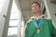 30 September 2004; David Malone, a member of the Ireland Paralympic team, and silver medallist in the 100m backstroke S8, on the teams arrival home from Athens. Dublin Airport, Dublin. Picture credit; Brian Lawless / SPORTSFILE