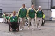 30 September 2004; The Ireland Paralympic team led by medal winners, from left, John McCarthy, Silver medallist in the F32/51 Discus, David Malone, Silver medallist in the 100m backstroke S8, Derek Malone, Bronze medallist in the T38 800m, and Conall McNamara, Silver Medallist in the T13 400m, on their arrival home from Athens. Dublin Airport, Dublin. Picture credit; Brian Lawless / SPORTSFILE