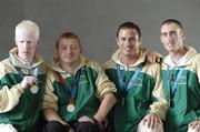 30 September 2004; Members of The Ireland Paralympics team, from left, Conall McNamara, Silver Medallist in the T13 400m, John McCarthy, Silver medallist in the F32/51 Discus, David Malone, Silver medallist in the 100m backstroke S8, and Derek Malone, Bronze medallist in the T38 800m, on the teams arrival home from Athens. Dublin Airport, Dublin. Picture credit; Brian Lawless / SPORTSFILE