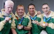 30 September 2004; Members of The Ireland Paralympics team, from left, Conall McNamara, Silver Medallist in the T13 400m, John McCarthy, Silver medallist in the F32/51 Discus, David Malone, Silver medallist in the 100m backstroke S8, and Derek Malone, Bronze medallist in the T38 800m, on the teams arrival home from Athens. Dublin Airport, Dublin. Picture credit; Brian Lawless / SPORTSFILE