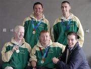 30 September 2004; Olympic Gold Medallist Cian O'Connor, right, meets with members of The Ireland Paralympics team, front from left, Conall McNamara, Silver Medallist in the T13 400m, John McCarthy, Silver medallist in the F32/51 Discus, back left, David Malone, Silver medallist in the 100m backstroke S8, and Derek Malone, Bronze medallist in the T38 800m, on the teams arrival home from Athens. Dublin Airport, Dublin. Picture credit; Brian Lawless / SPORTSFILE