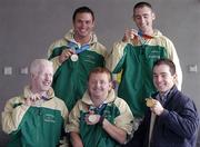 30 September 2004; Olympic Gold Medallist Cian O'Connor, right, meets with members of The Ireland Paralympics team, front from left, Conall McNamara, Silver Medallist in the T13 400m, John McCarthy, Silver medallist in the F32/51 Discus, back left, David Malone, Silver medallist in the 100m backstroke S8, and Derek Malone, Bronze medallist in the T38 800m, on the teams arrival home from Athens. Dublin Airport, Dublin. Picture credit; Brian Lawless / SPORTSFILE