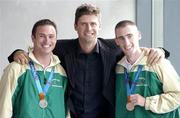 30 September 2004; Niall Quinn, ex-Republic of Ireland International, with members of The Ireland Paralympics team David Malone, left, Silver medallist in the 100m backstroke S8, and Derek Malone, Bronze medallist in the T38 800m, on the teams arrival home from Athens. Dublin Airport, Dublin. Picture credit; Brian Lawless / SPORTSFILE
