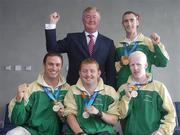 30 September 2004; John O'Donoghue TD, Minister for Arts, Sport and Tourism, with members of The Ireland Paralympics team, front row from left, David Malone, Silver medallist in the 100m backstroke S8, John McCarthy, Silver medallist in the F32/51 Discus, Conall McNamara, Silver Medallist in the T13 400m, and, back right, Derek Malone, Bronze medallist in the T38 800m, on the teams arrival home from Athens. Dublin Airport, Dublin. Picture credit; Brian Lawless / SPORTSFILE