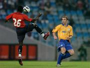 30 September 2004; Angbwa Benoit, Lille, in action against Ollie Cahill, Shelbourne. UEFA cup, First Round, Second Leg, Lille v Shelbourne, Stade Metropole, Lille, France. Picture credit; David Maher / SPORTSFILE