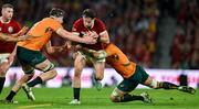 19 July 2025; Hugo Keenan of British & Irish Lions is tackled by Australia players Nick Frost, left, and Nick Champion de Crespigny during the first test match between Australia and the British & Irish Lions at Suncorp Stadium in Brisbane, Australia. Photo by Brendan Moran/Sportsfile
